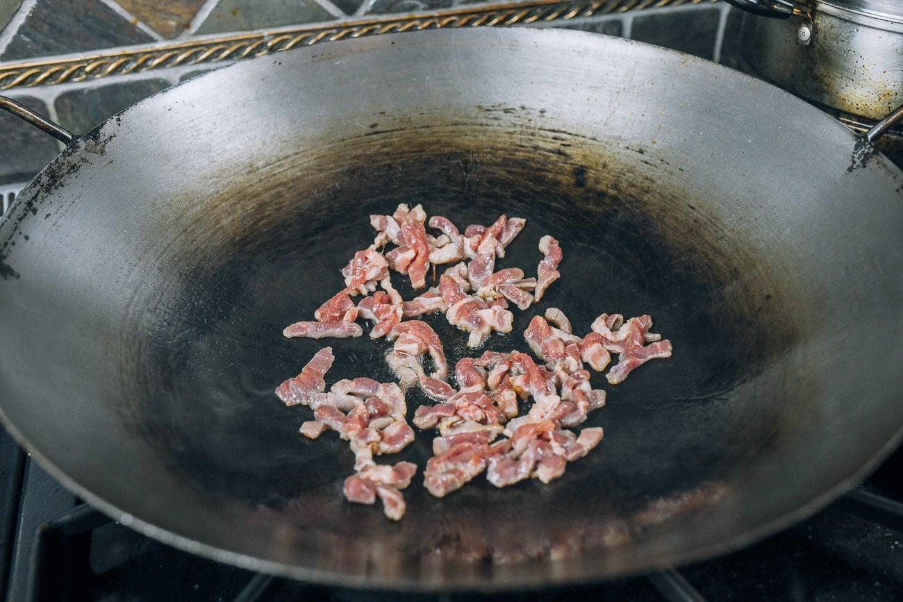 searing pork in wok