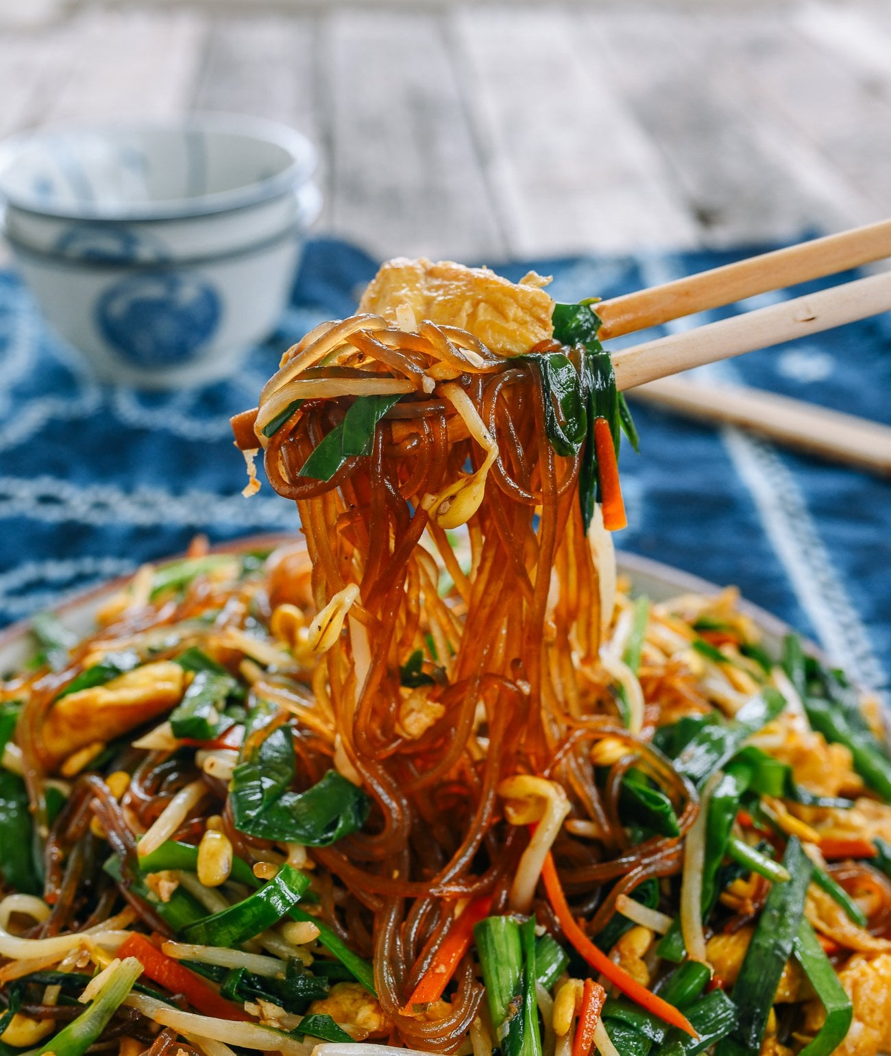 picking up glass noodles with chopsticks