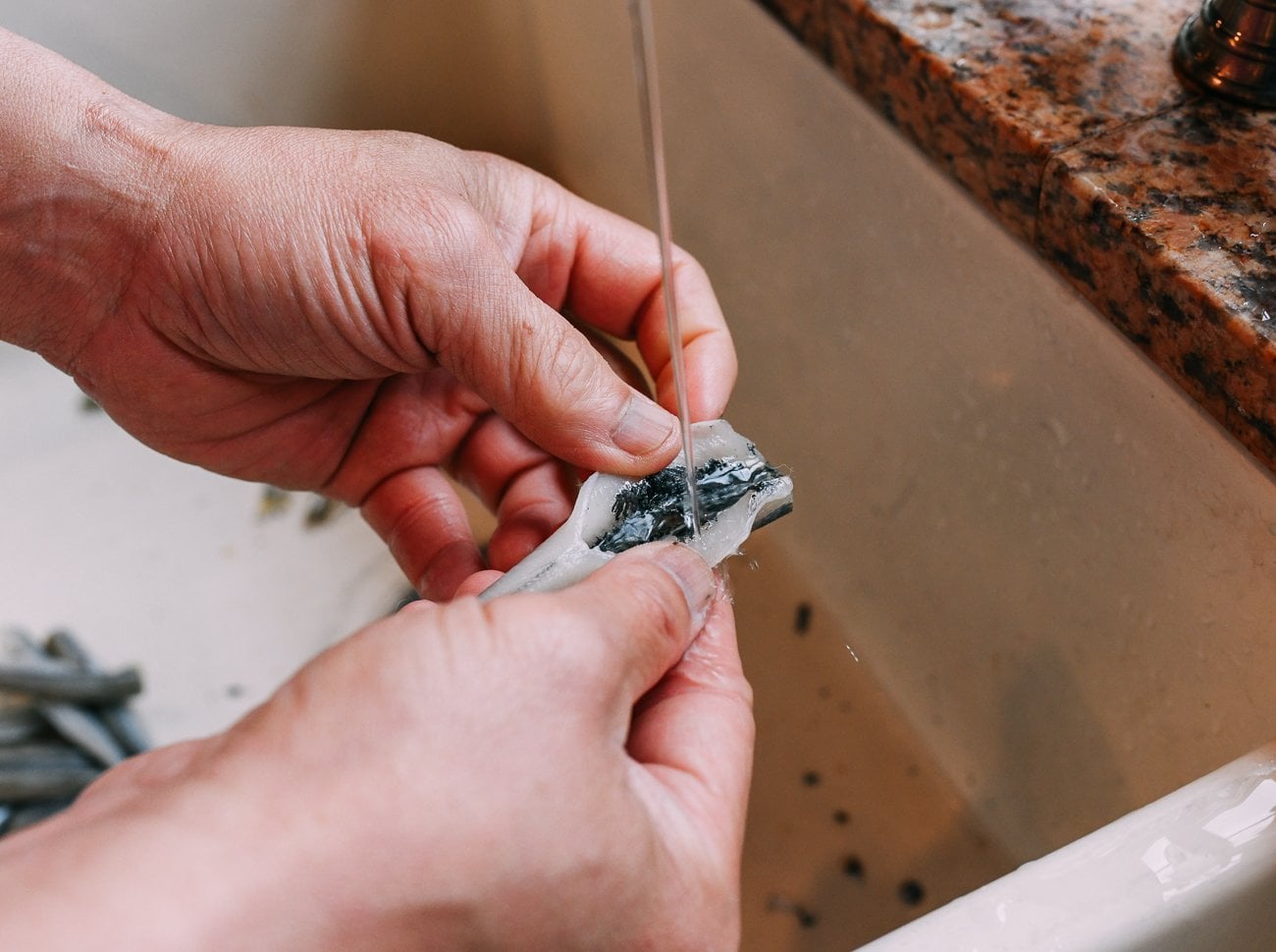 rinsing belly of smelt fish
