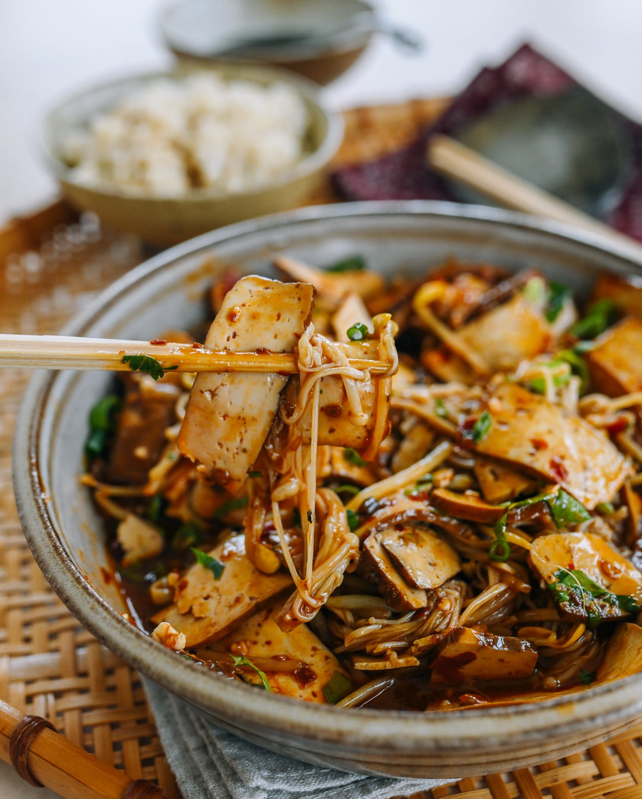 Picking up spicy doufugan with chopsticks