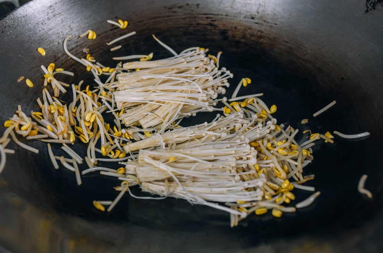 adding enoki mushrooms to soybean sprouts