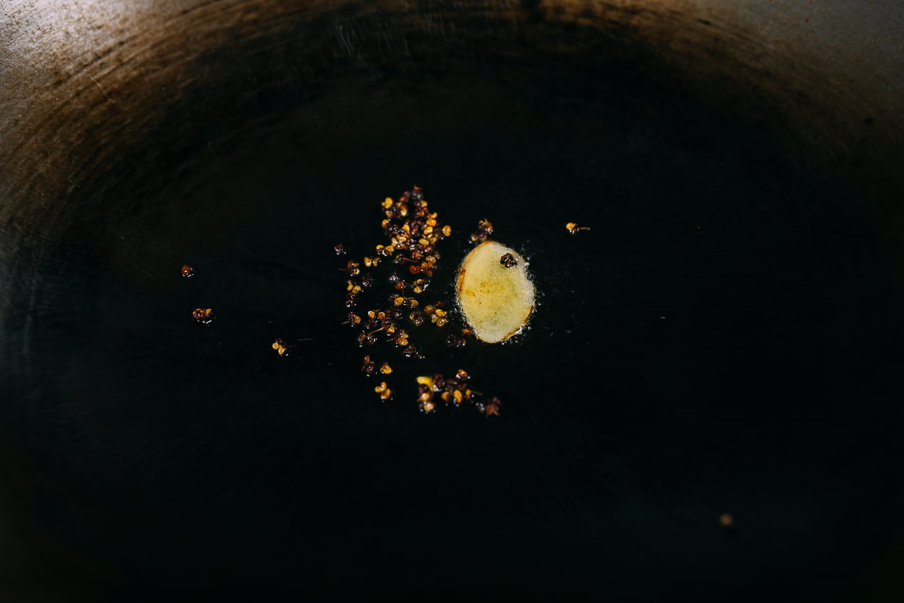 ginger and Sichuan peppercorns in wok