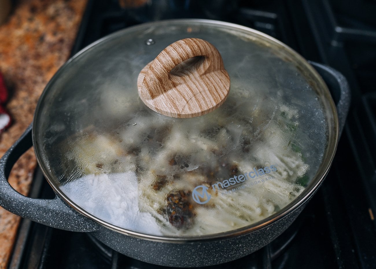 covered pan with enoki mushrooms