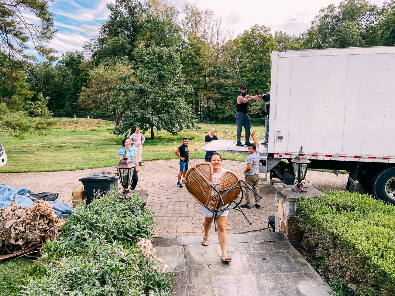 kaitlin moving a chair into the house