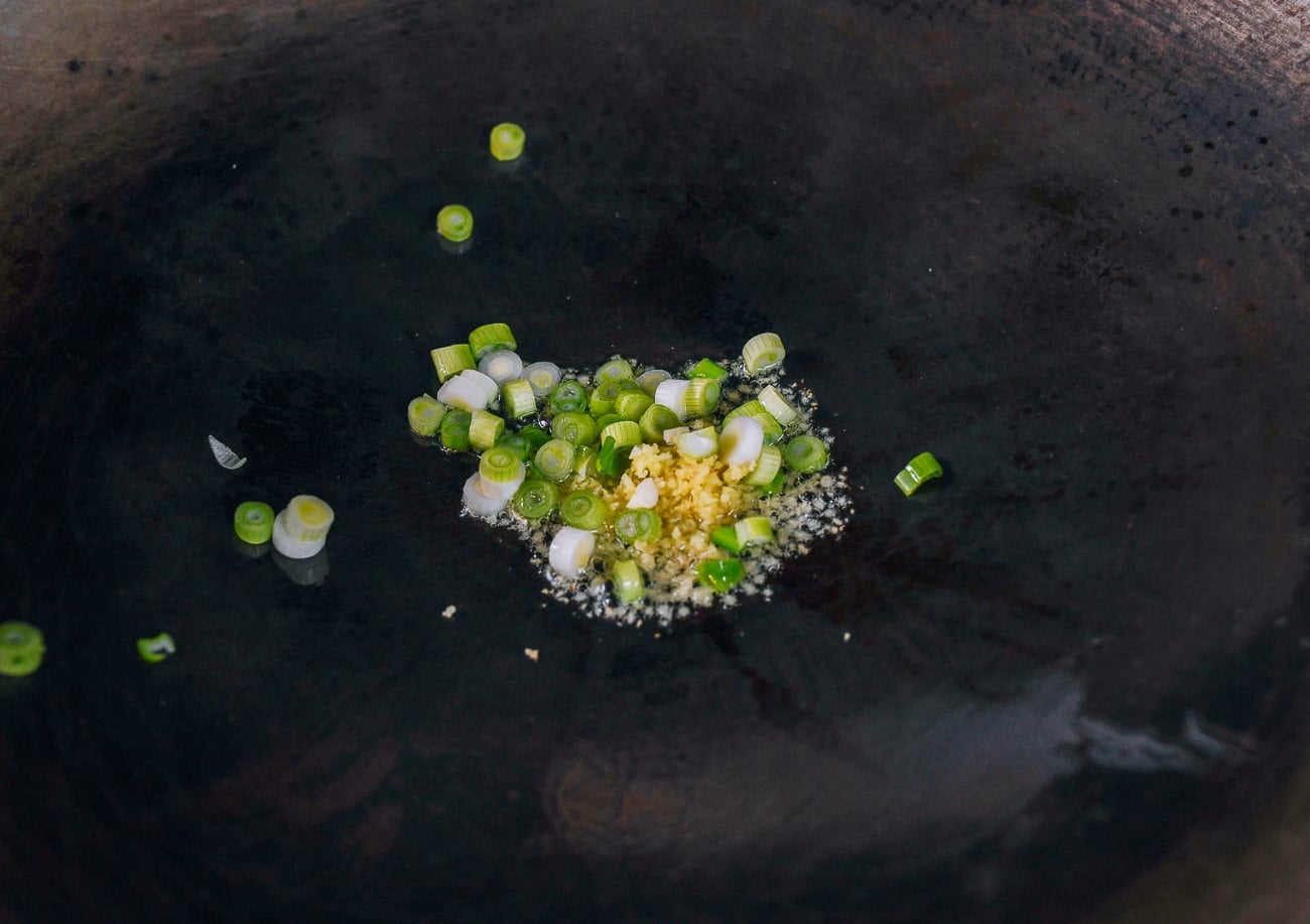 oil, ginger and scallion whites in oil in wok