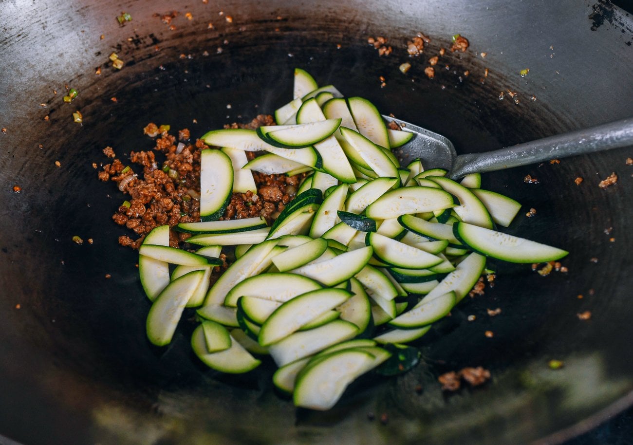 stirring zucchini into ground meat mixture