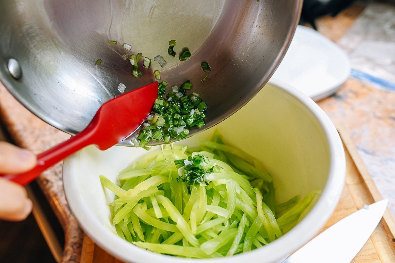 Pouring scallion oil onto celtuce