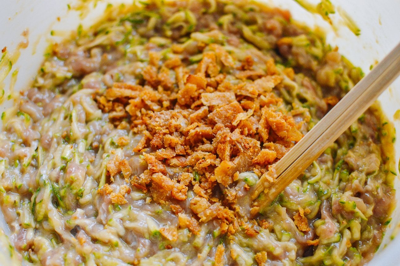adding crispy chicken skin to dumpling filling