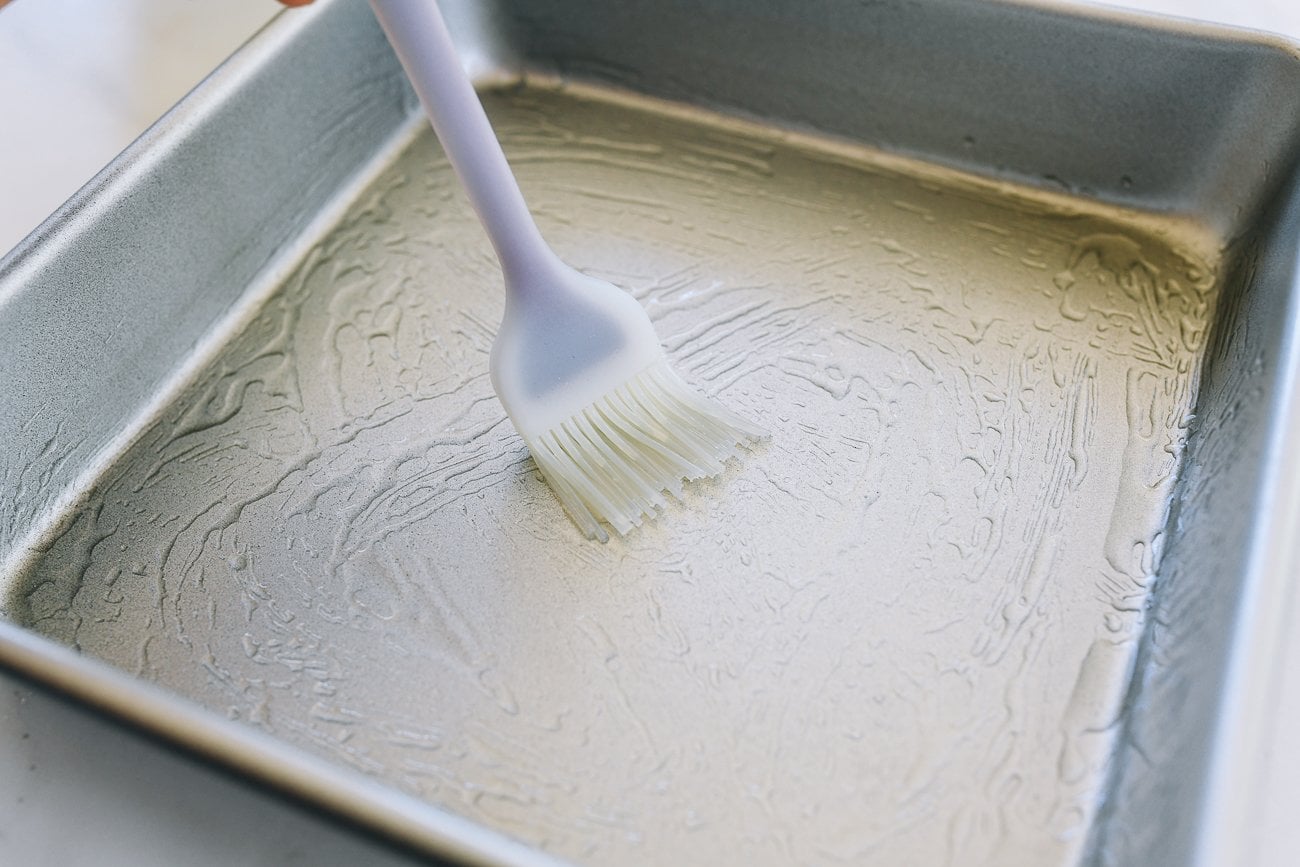 brushing square pan with oil