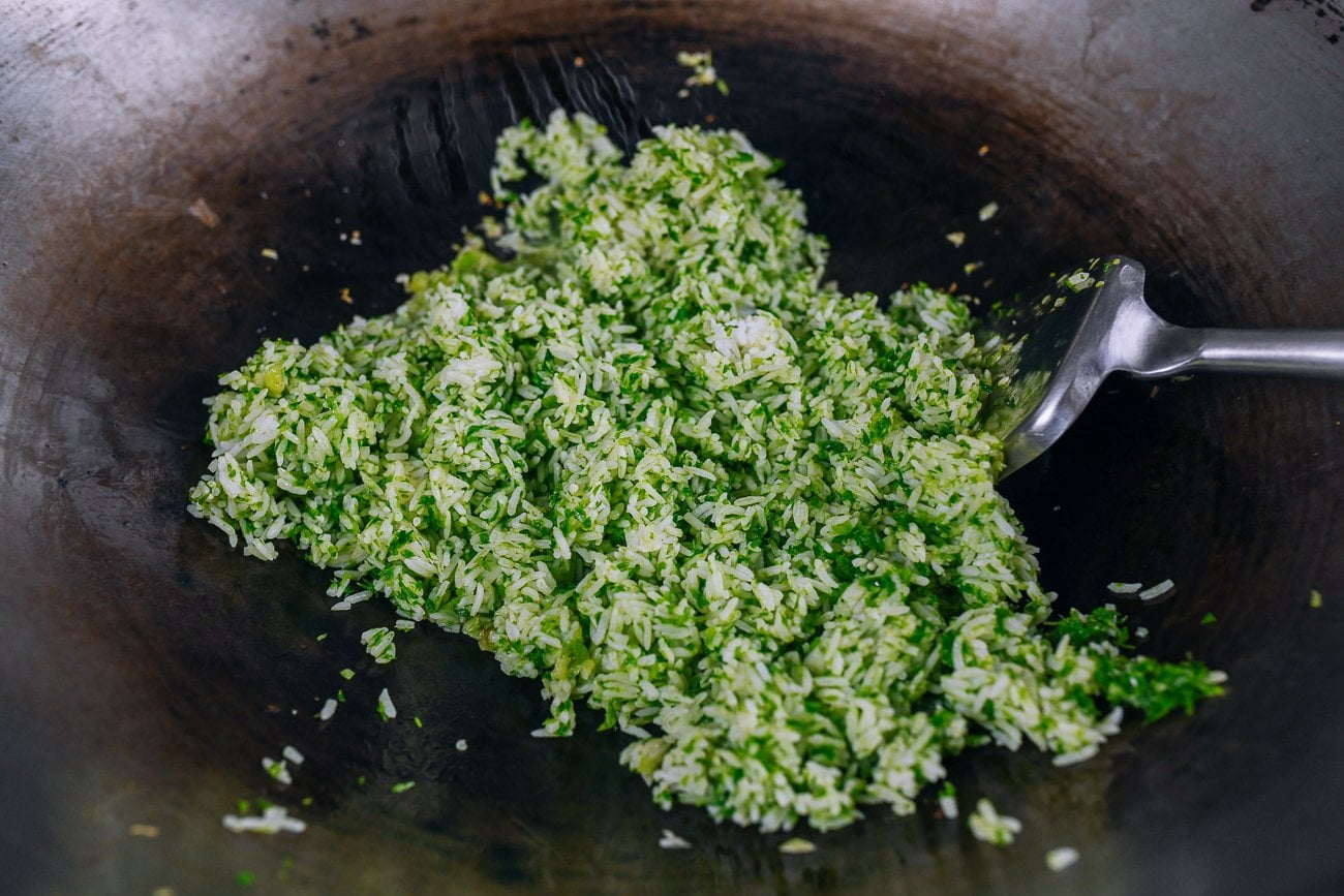 adding scallion rice to wok