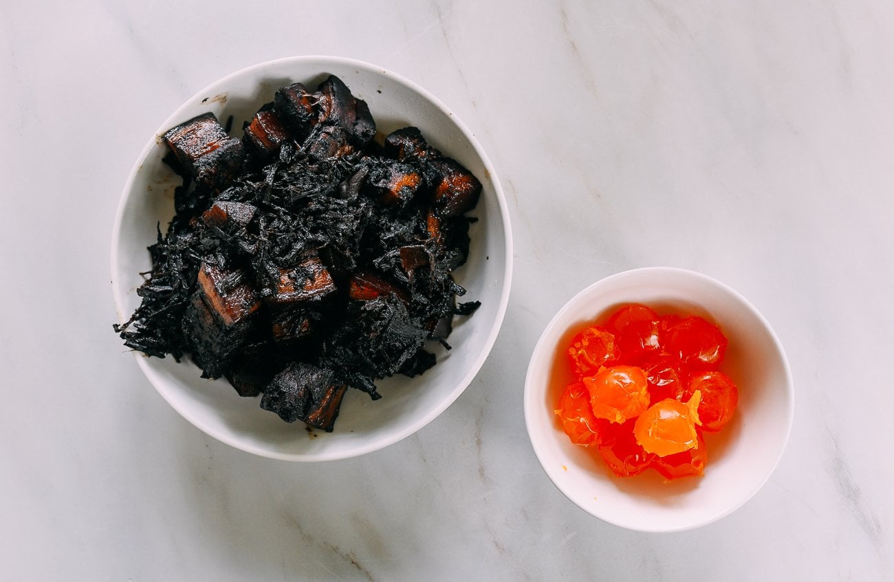pork belly with mei cai and salted duck egg yolks in separate bowls