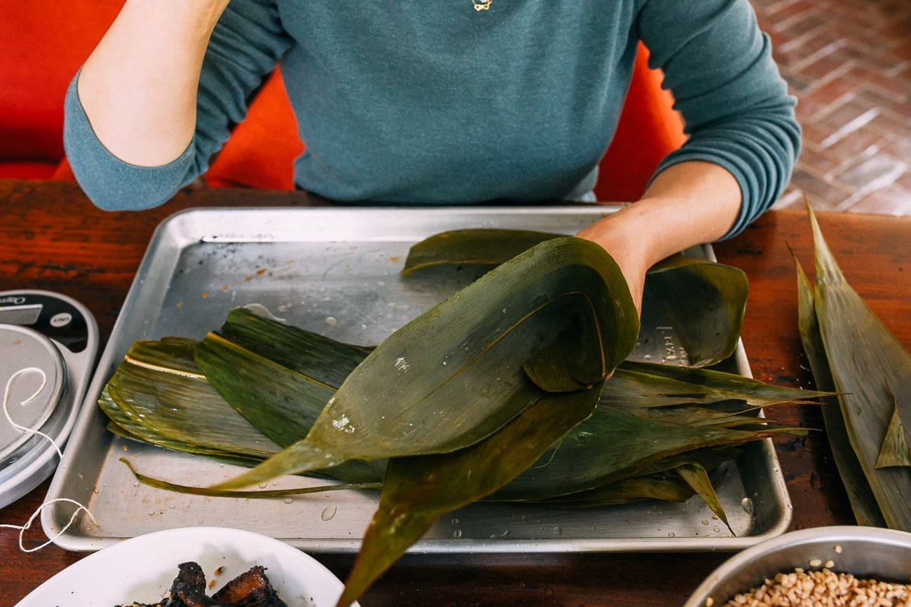forming a cone with zongzi leaves