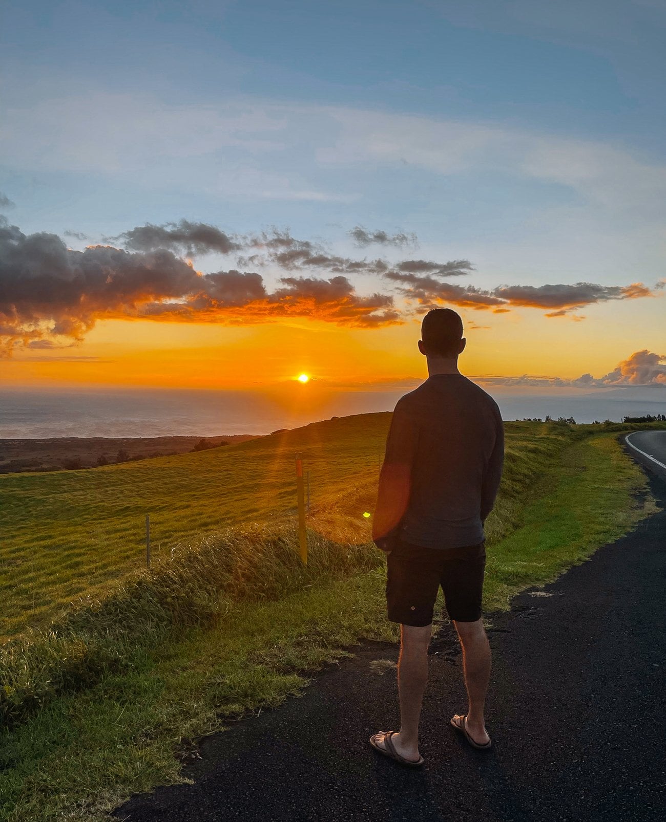 Justin watching sunset from slopes of Kohala