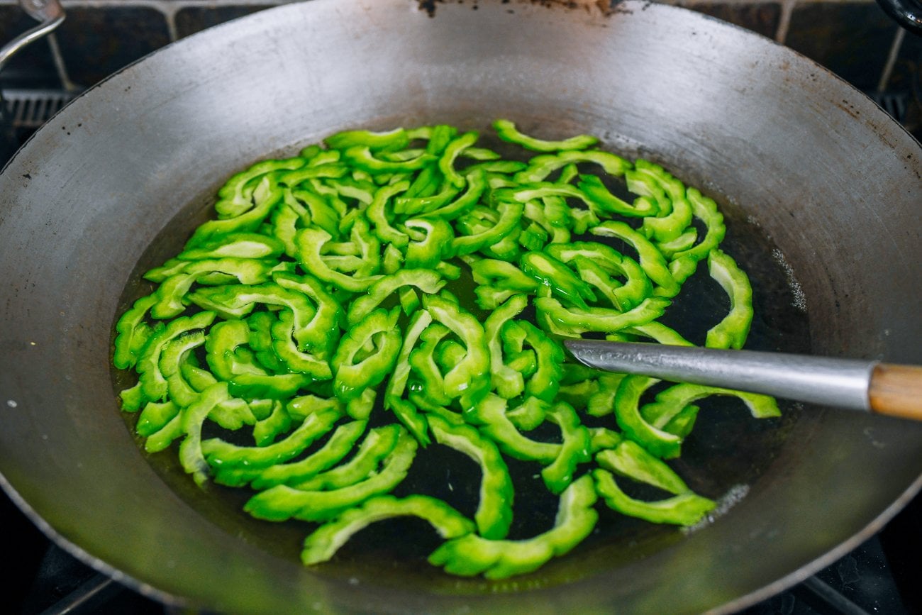 blanching bitter melon slices in water