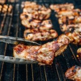 grilling individual ribs with metal tongs