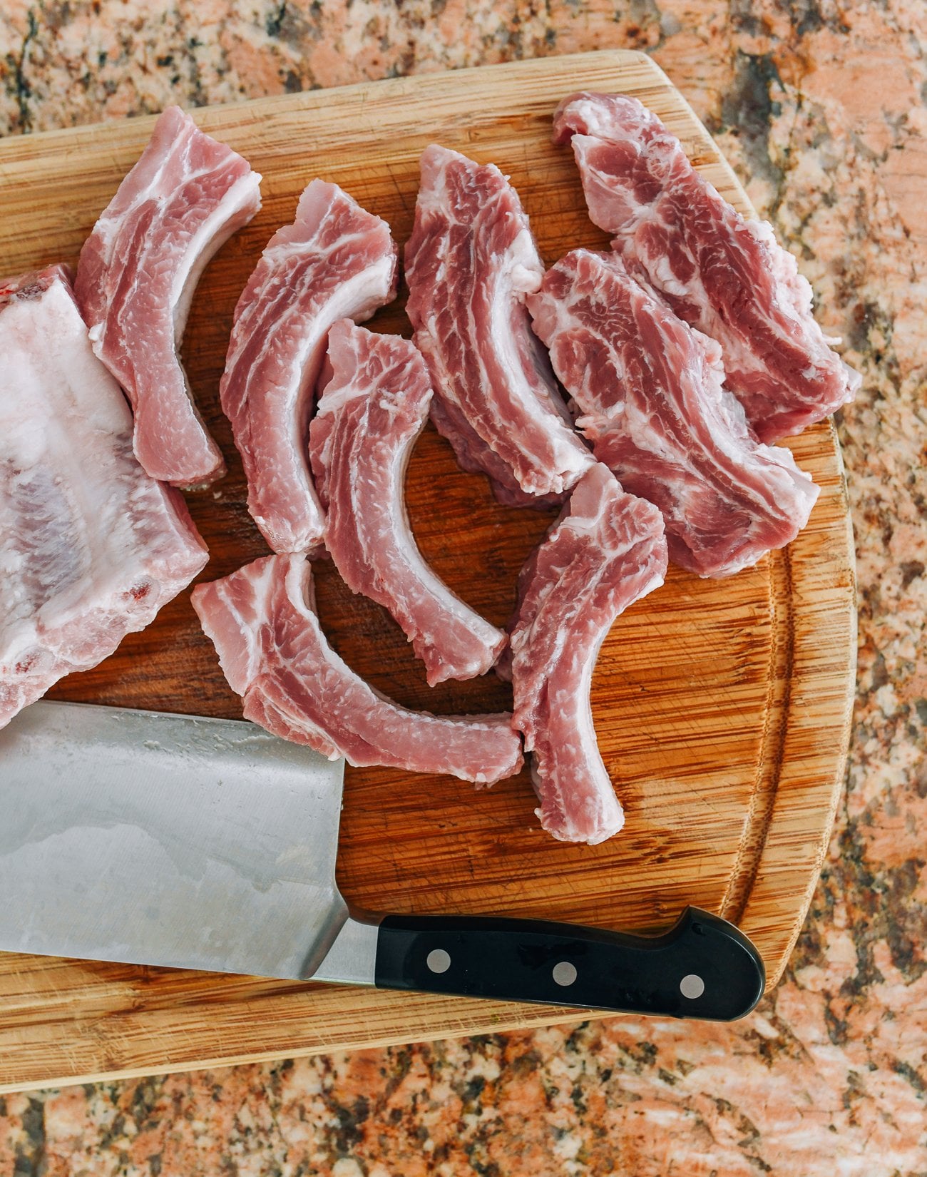 cutting rack of baby back ribs into individual ribs