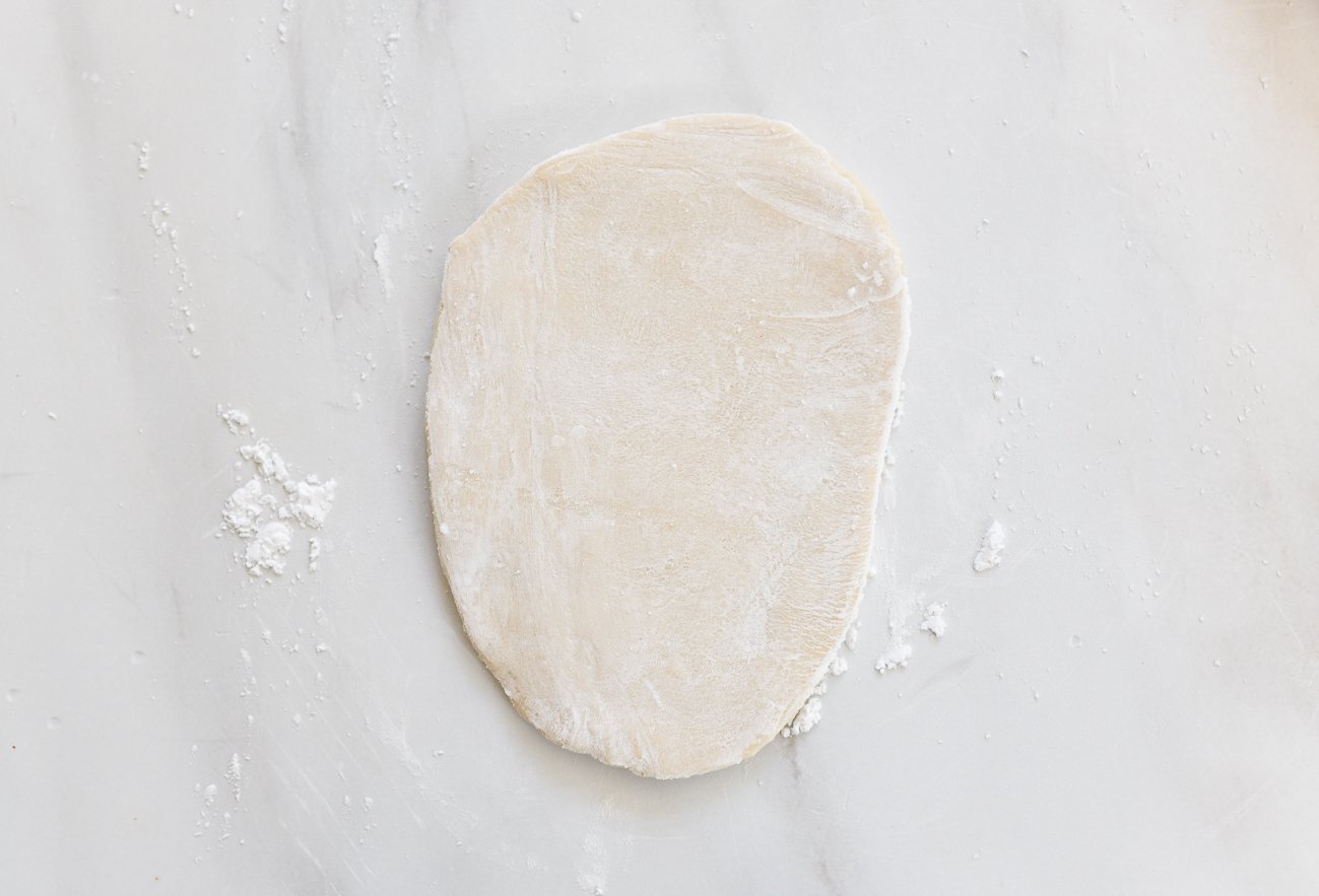 flat piece of dough dusted with cornstarch