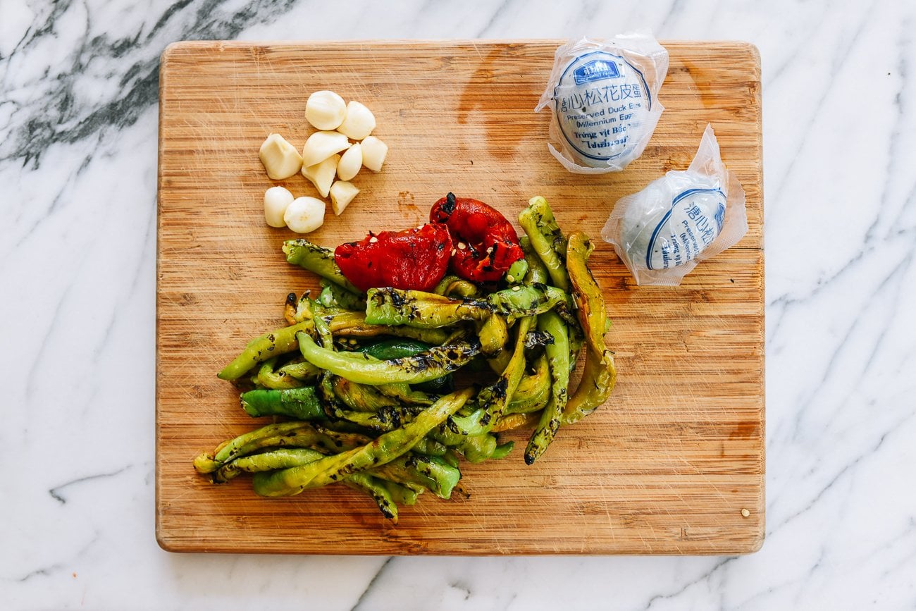 garlic cloves, charred peppers, and century eggs