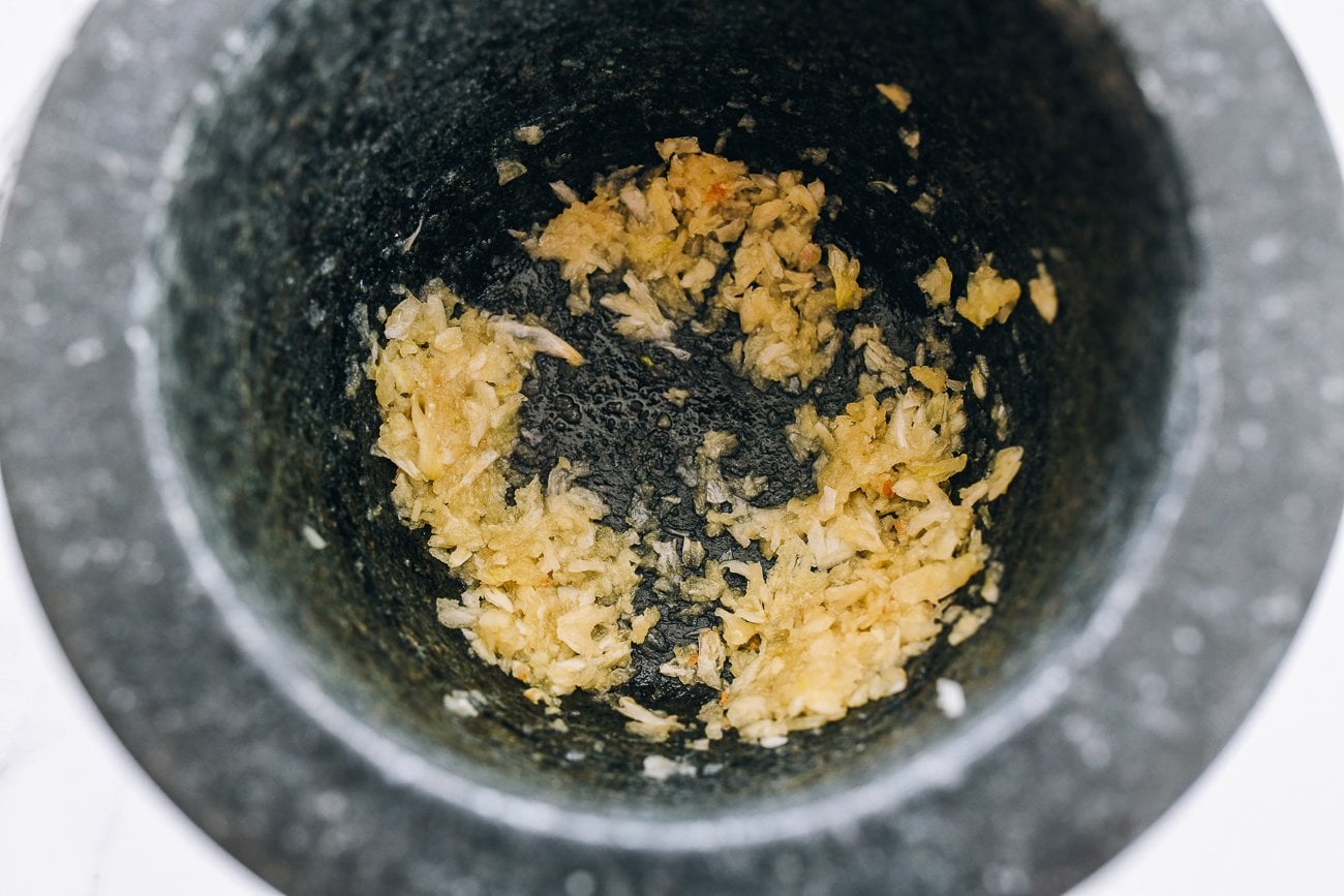 smashed garlic in mortar