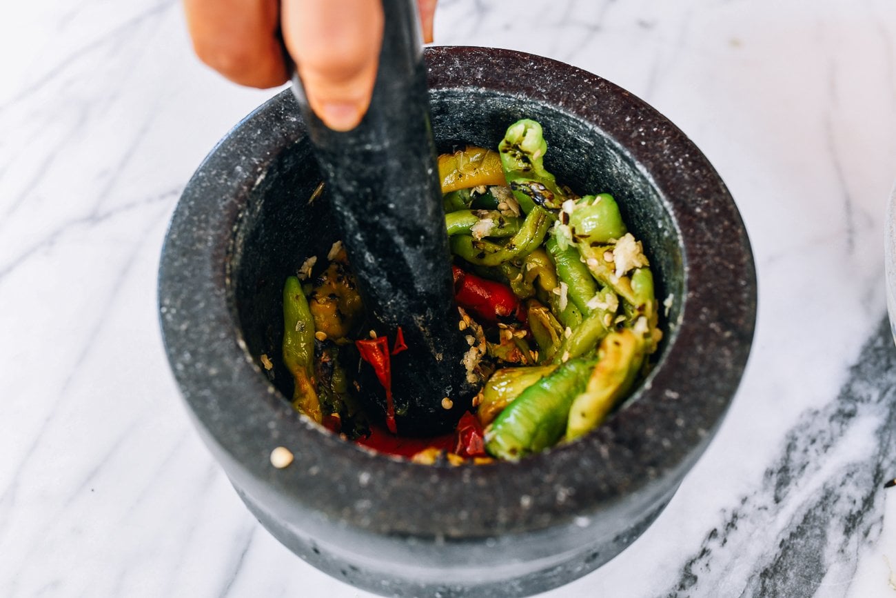 charred peppers in mortar and pestle