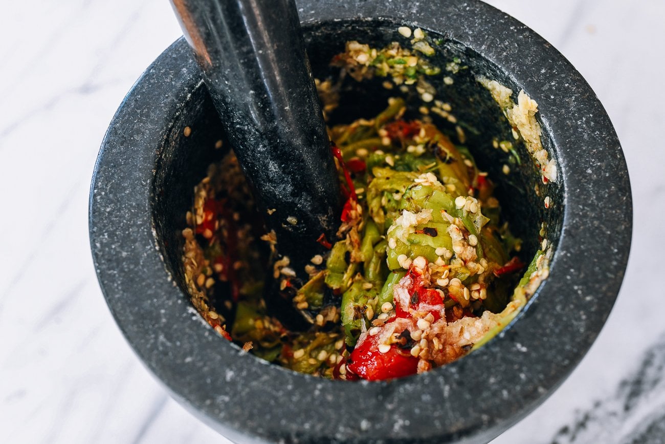 charred peppers in mortar and pestle