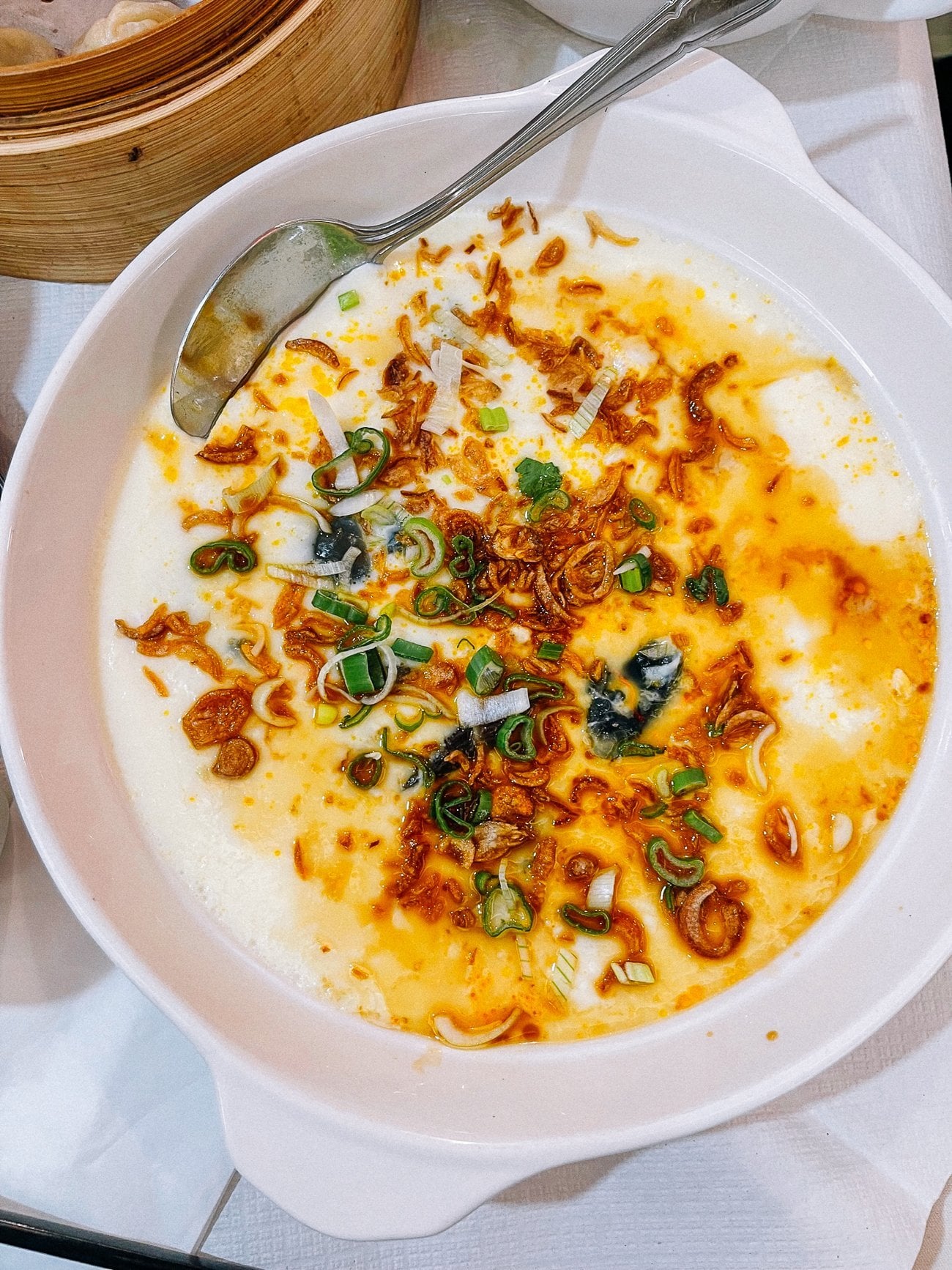 steamed eggs topped with scallions, fried shallots, and sweet soy sauce