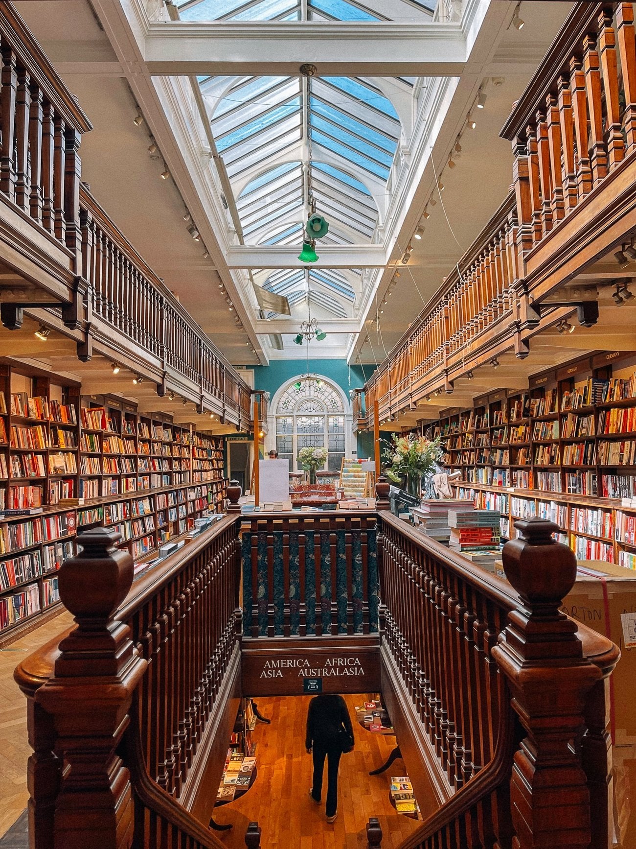 Daunt Bookstore interior with sky window and two levels of narrow walls of books