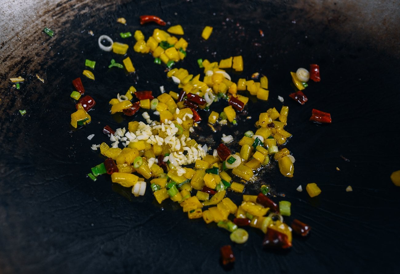 garlic, scallion, bell pepper, ginger and chilies in wok