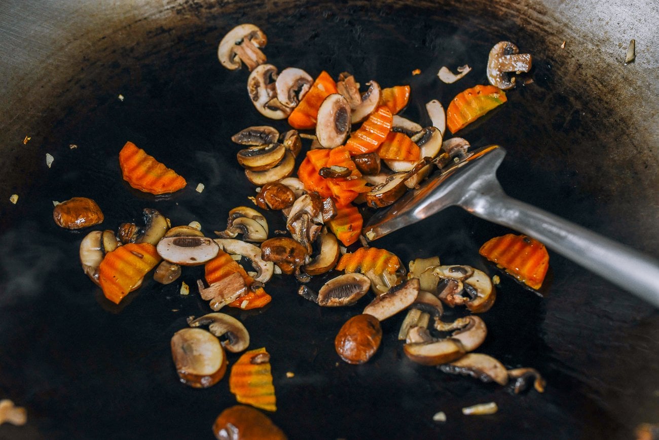 carrots and mushrooms in wok