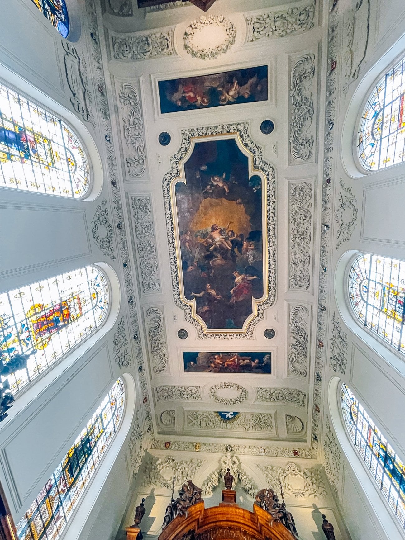 Oxford University chapel ornate ceiling and stained glass with religious paintings