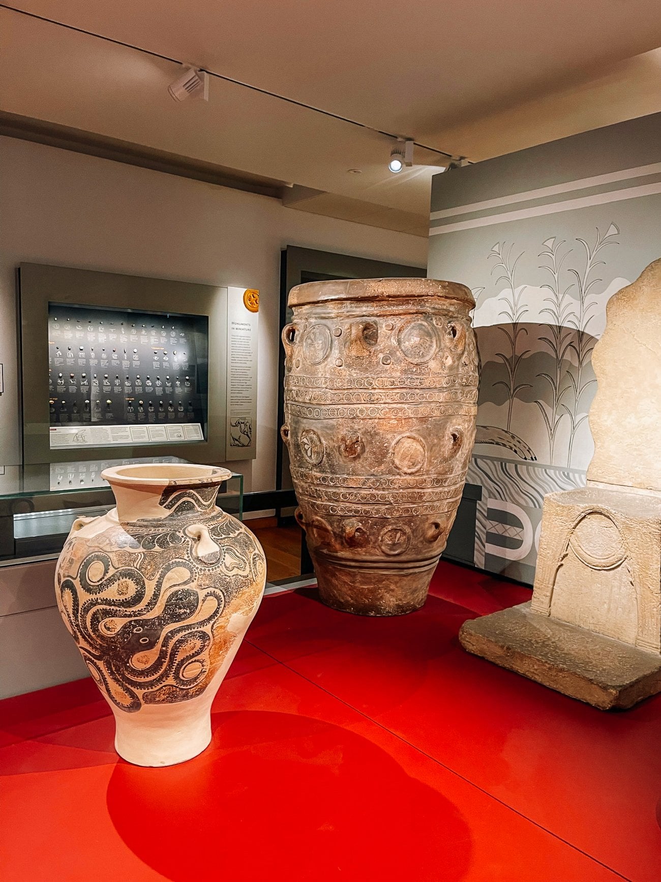 Ancient urns and vase with a black octopus on it