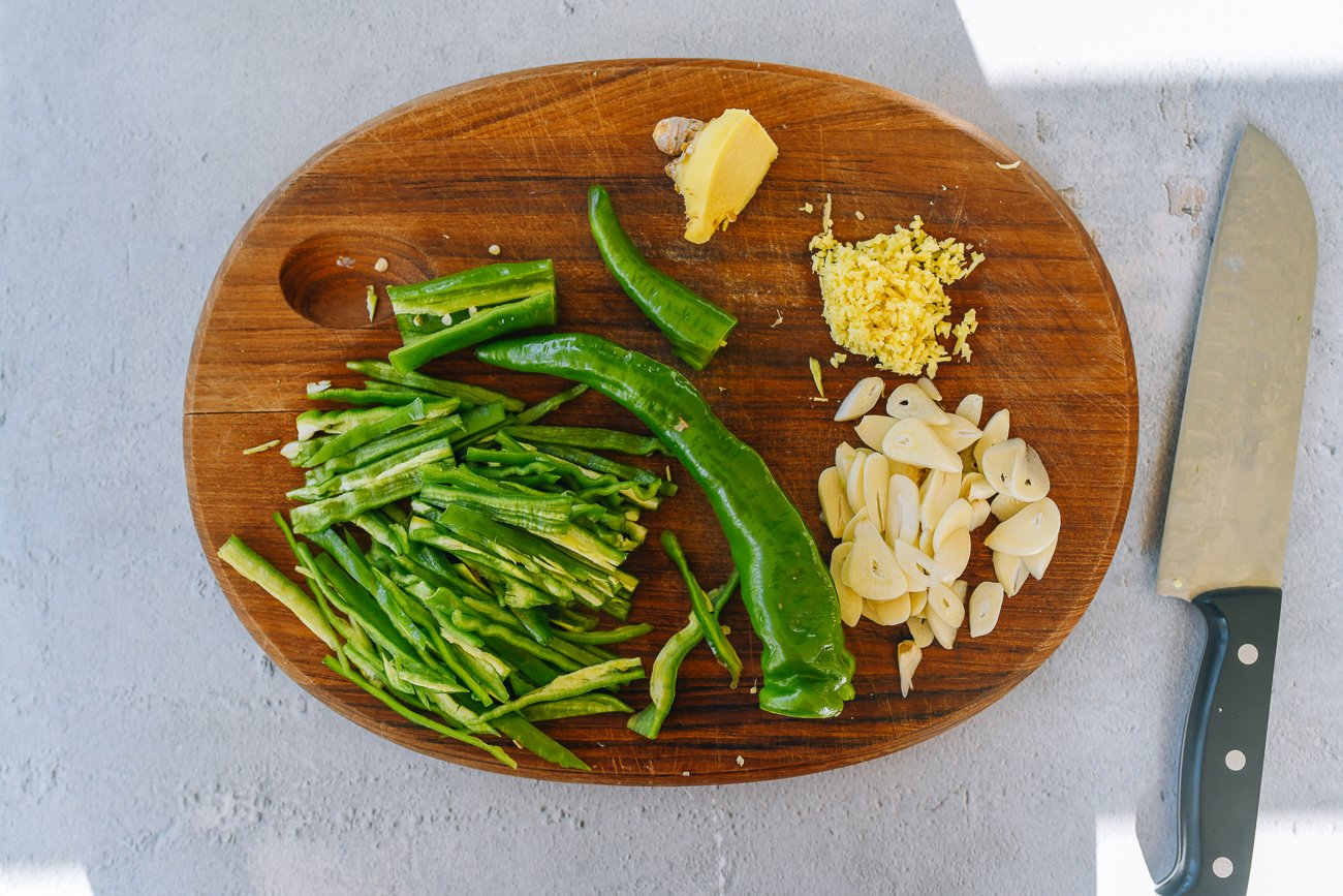 peppers, ginger, and garlic on cutting board