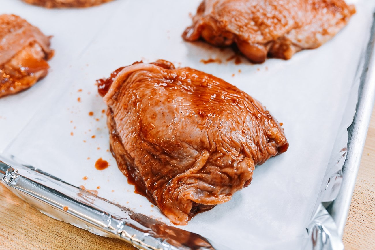 chicken thigh on parchment-lined sheet pan