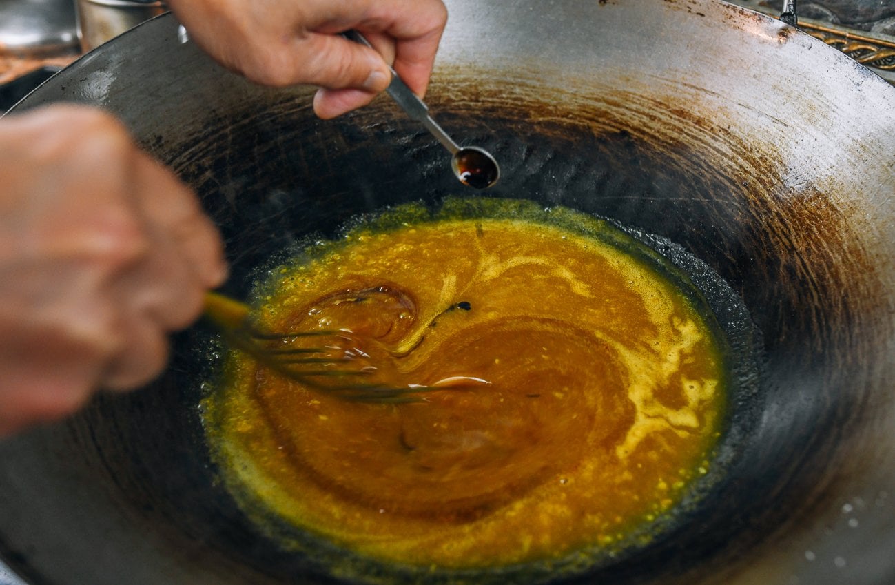 whisking dark soy sauce into gravy