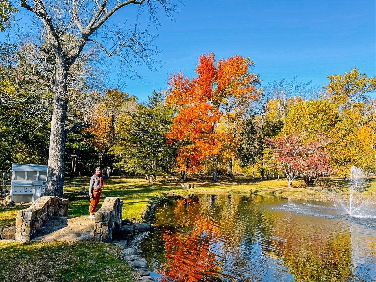 Sarah waving from stone bridge