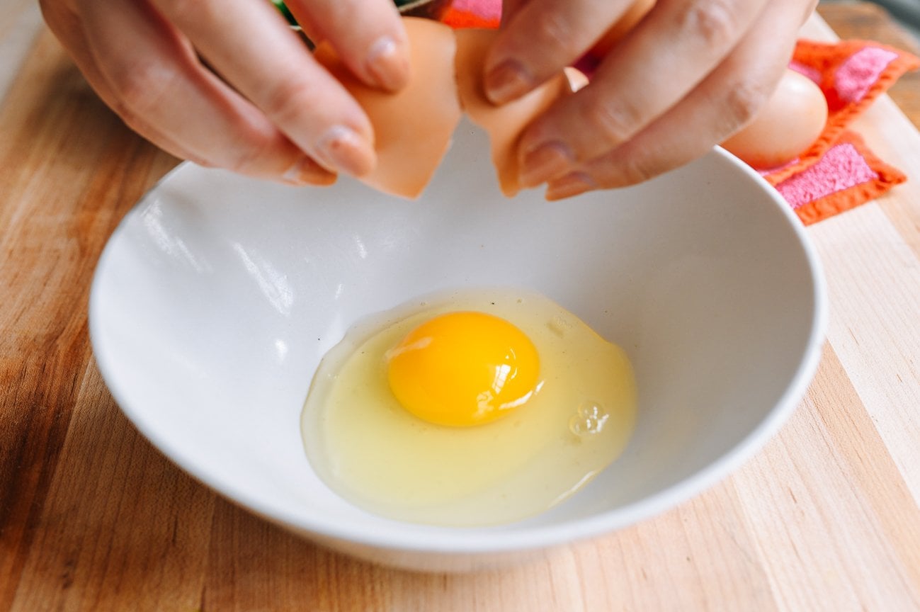 cracking eggs into bowl