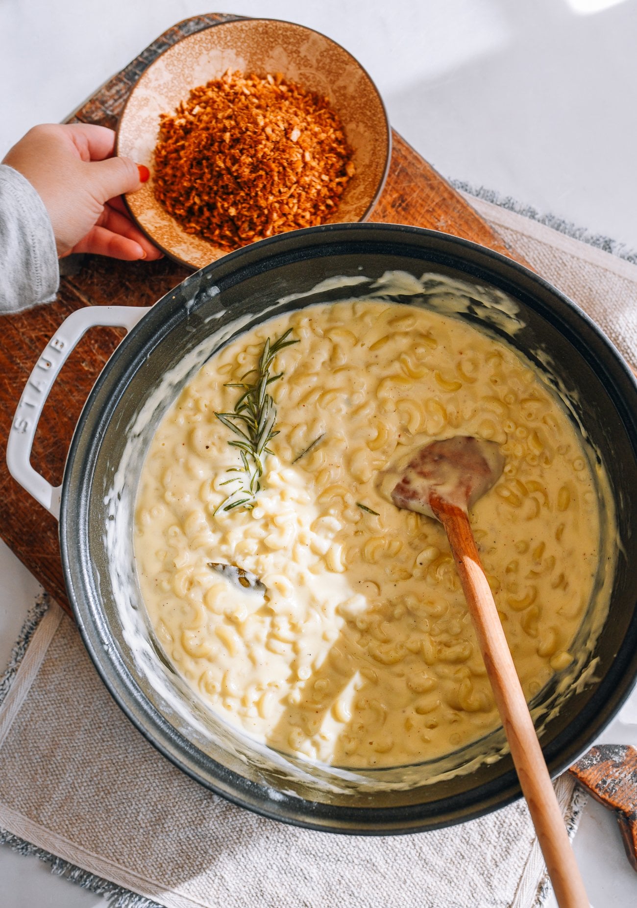 Pot of mac and cheese and bowl of toasted breadcrumbs