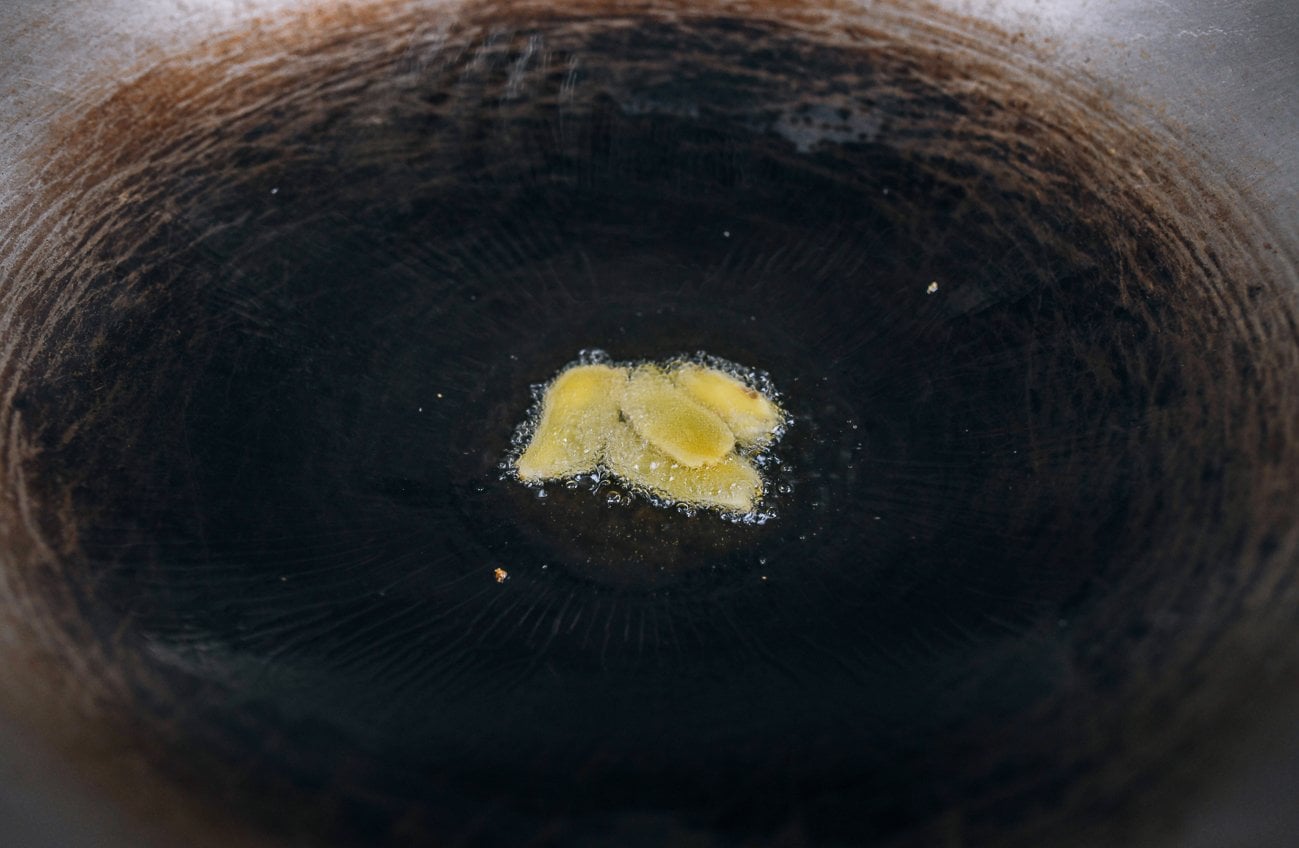 frying ginger slices in wok