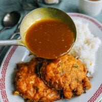 pouring gravy over egg foo young