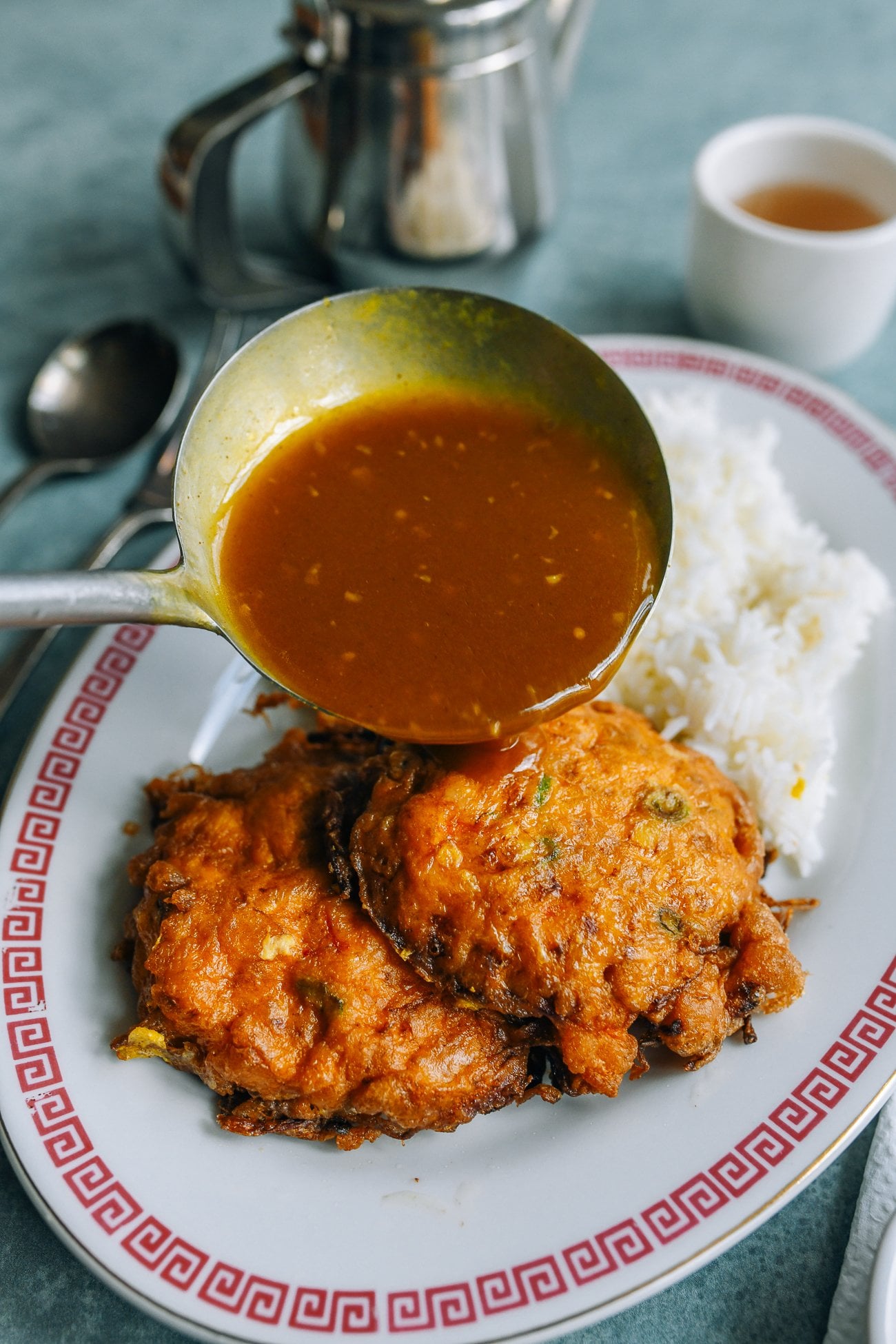 pouring gravy over egg foo young