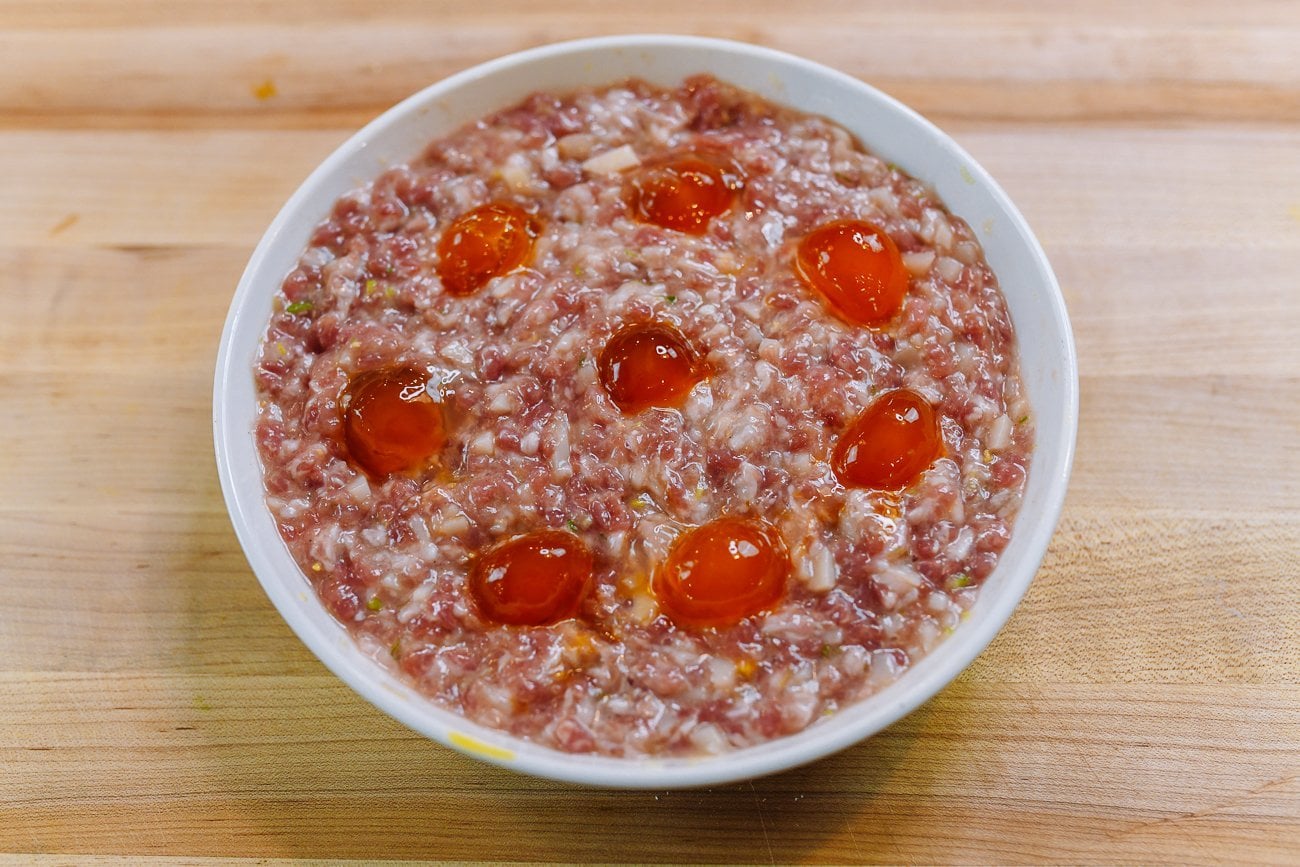 raw salted duck egg yolk halves on meat patty