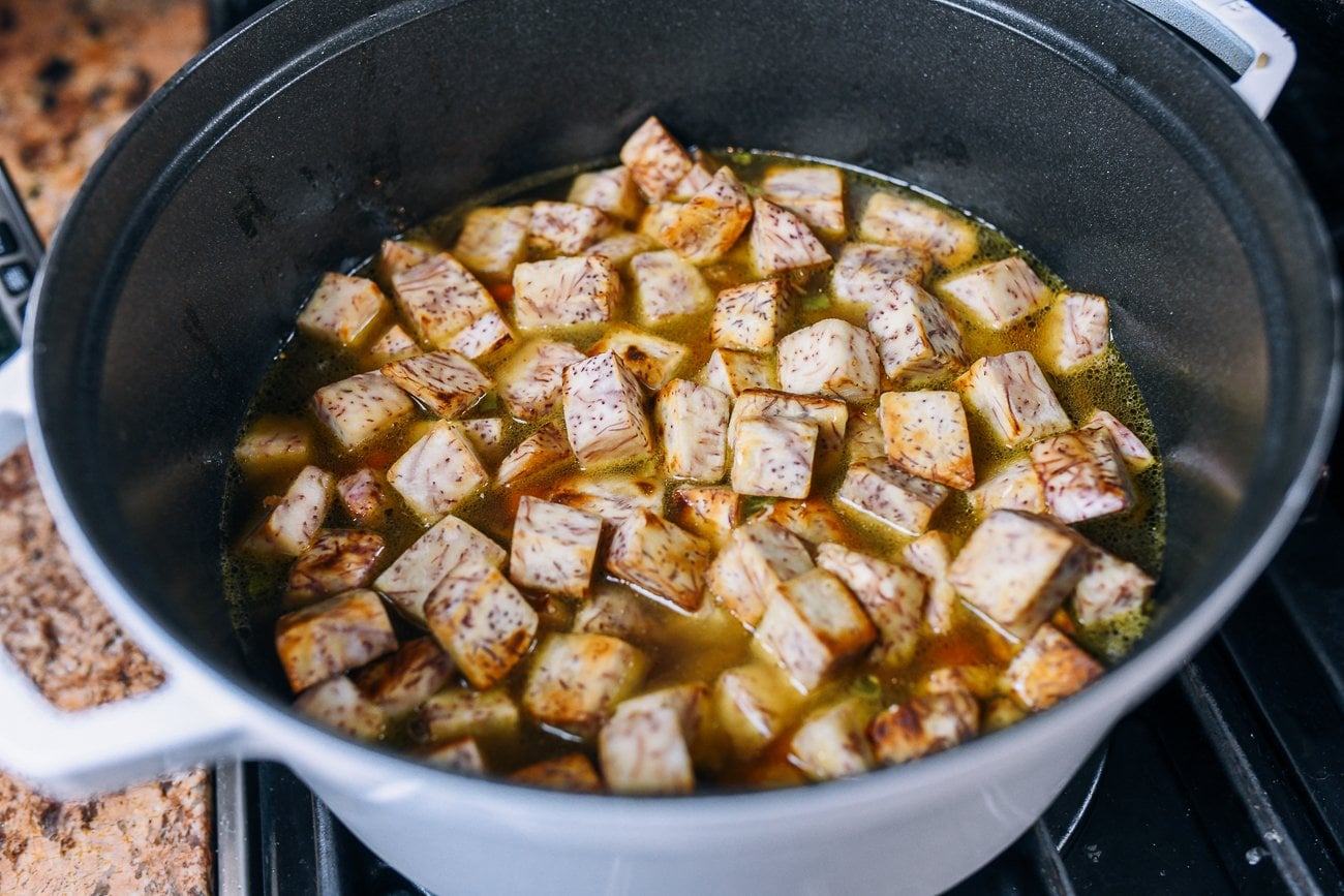 taro spread on top of rice in dutch oven