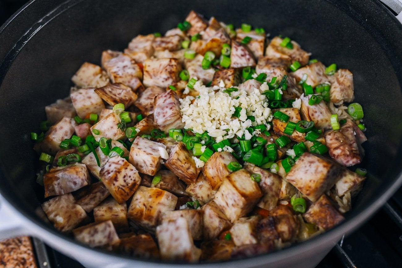 chopped scallion and garlic on top of taro and rice