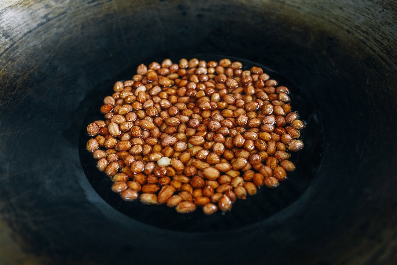 peanuts in wok with oil