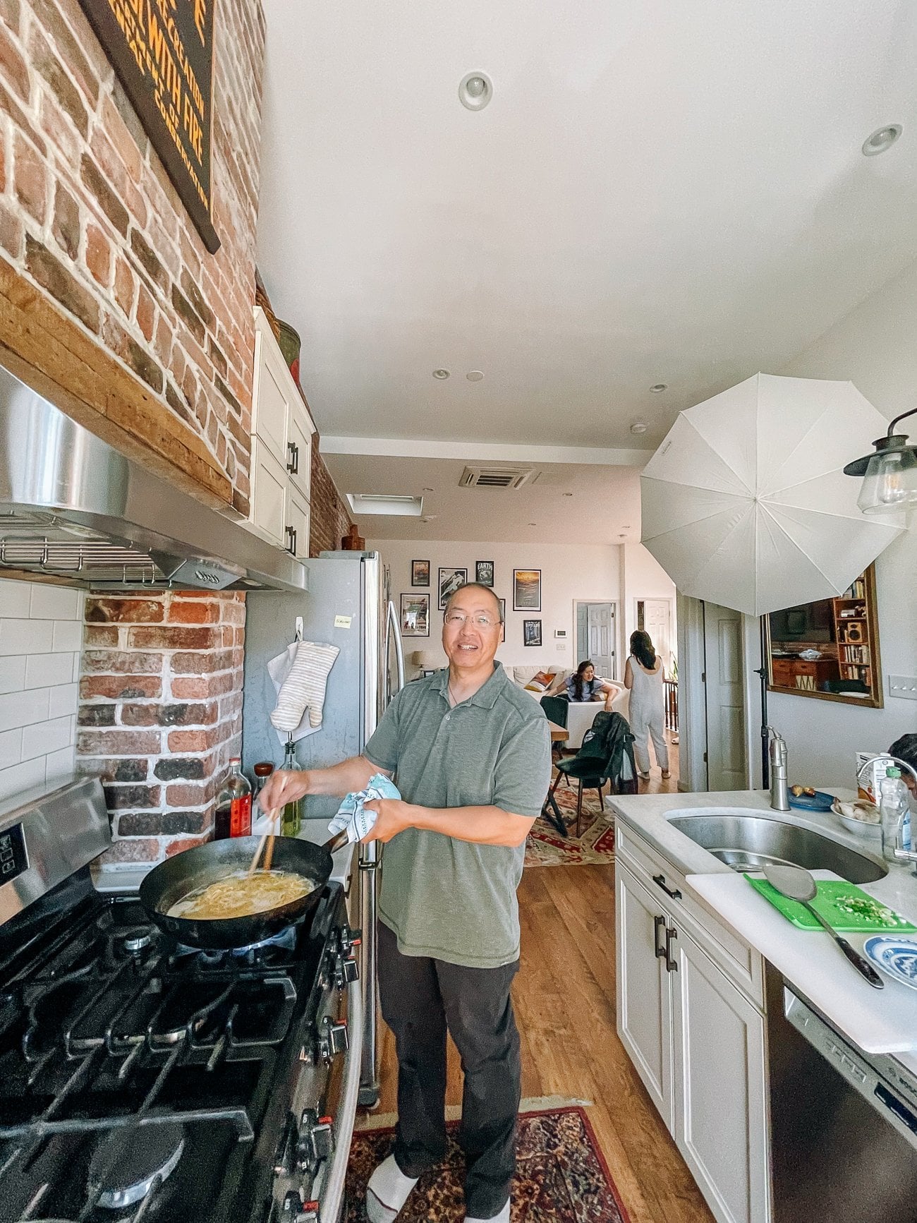 Bill cooking at the wok in Sarah's apartment