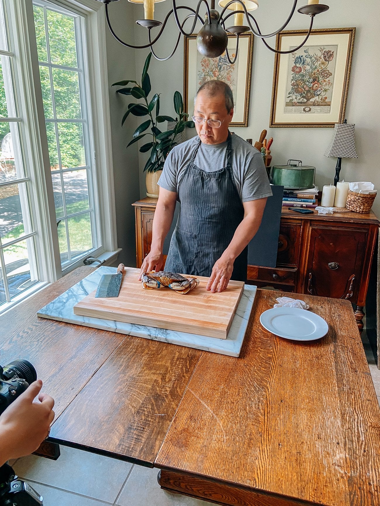 Bill getting ready to demonstrate crab technique for photos in cookbook behind the scenes
