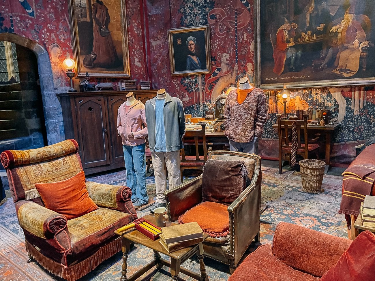 The Gryffindor common room at Harry Potter studio tour with Harry, Ron, and Hermione third movie mannequins.
