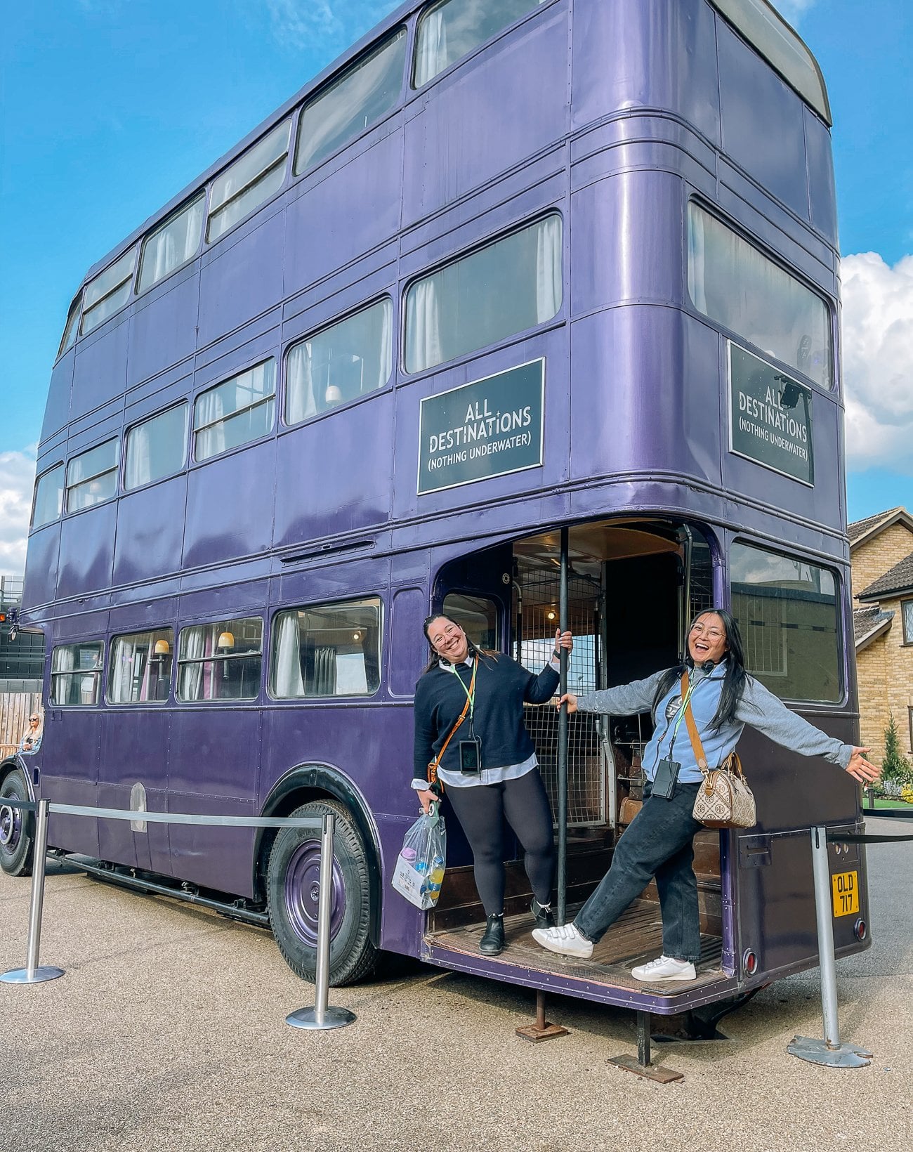Kim and Kaitlin posing on the purple night bus at Harry Potter studio tour