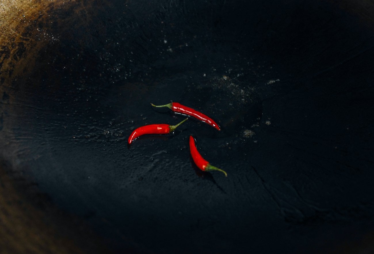 three whole thai bird's eye chilies in a wok