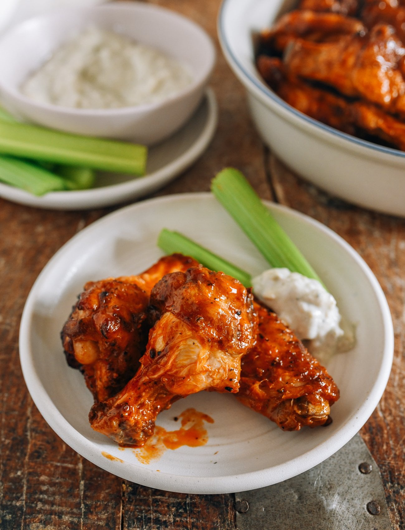 air fryer hot wings on plate with blue cheese and celery sticks